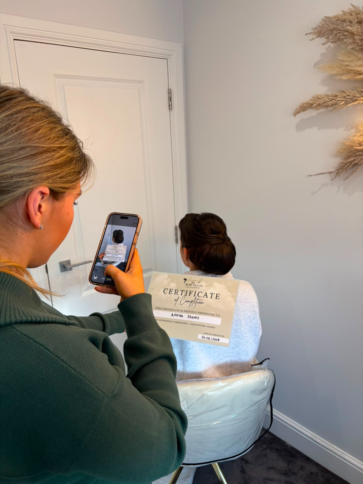 Student receiving her hair styling course certificate