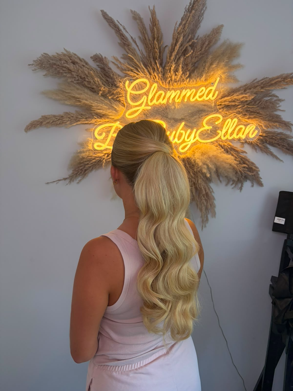 High ponytail with long glossy waves