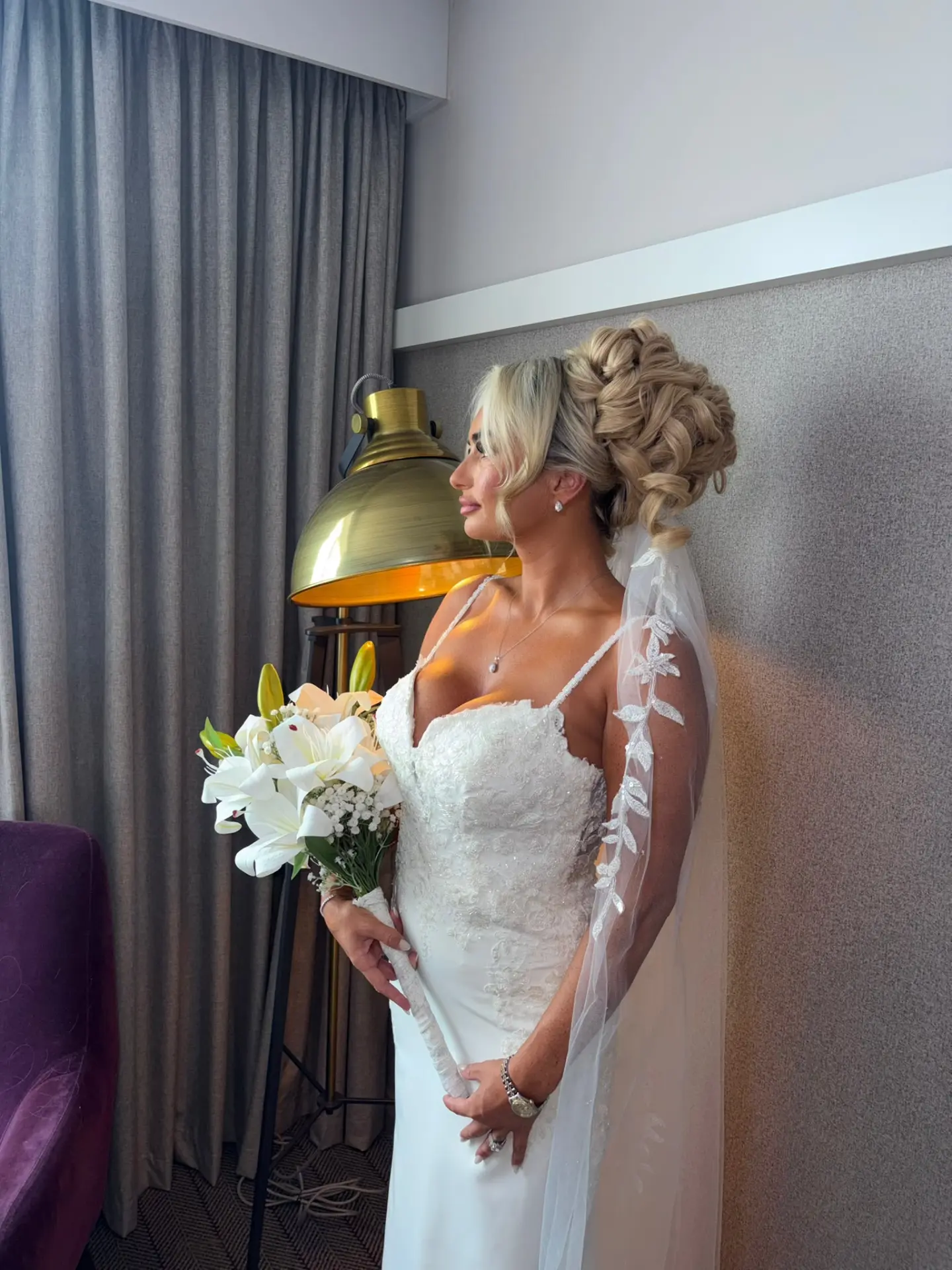 Bride with curled high bun and lace veil